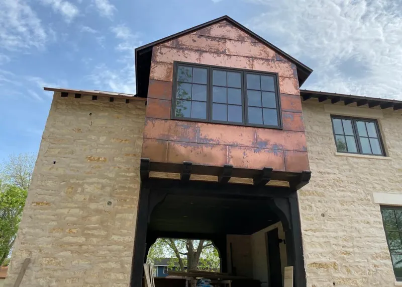 Copper metal panel facade on a stone building for Skylight Installation in Seven Oaks